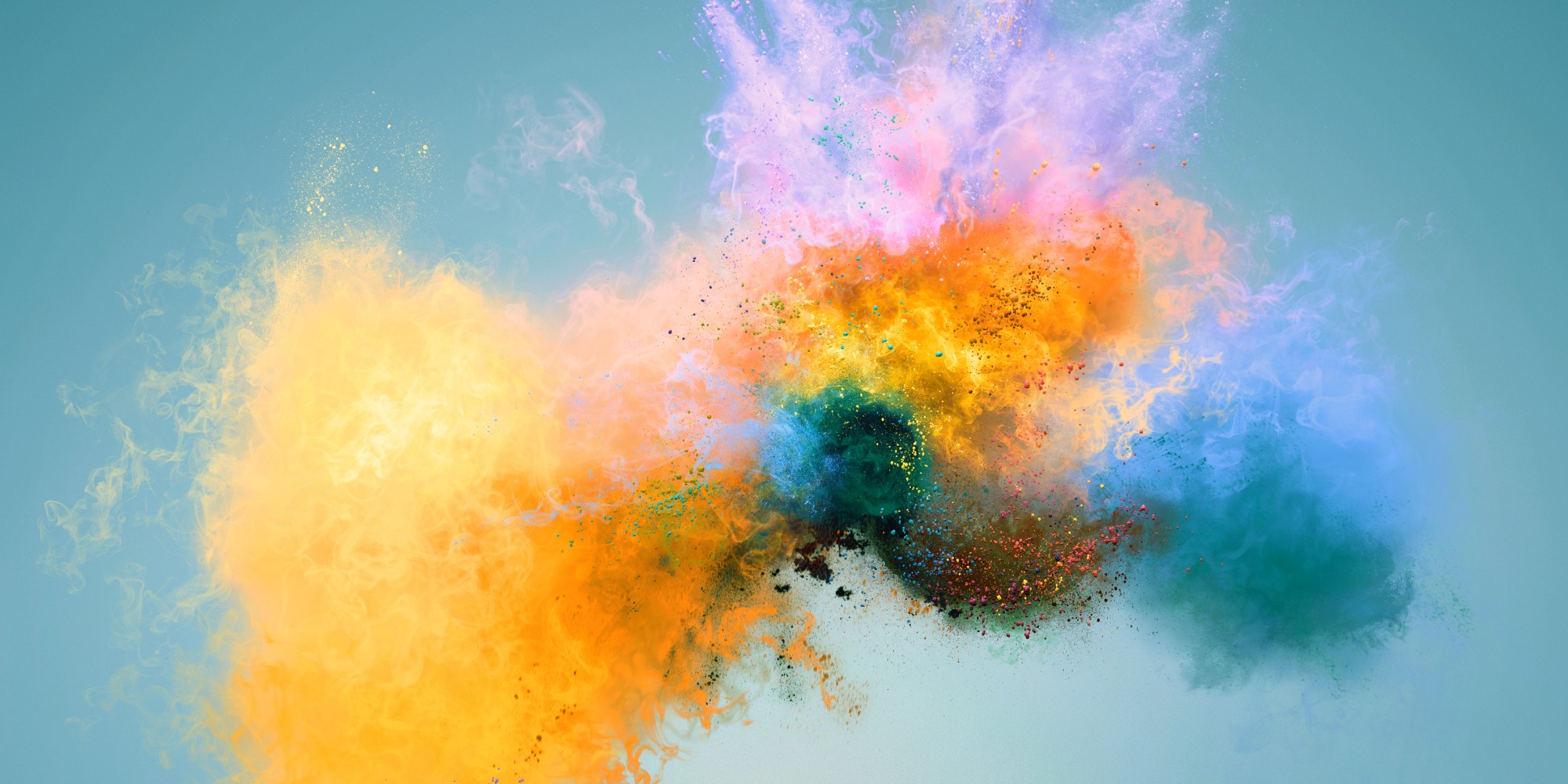 An explosion of colours, yellow, orange, red, purple, blue. All looking like dust particles on a light blue background