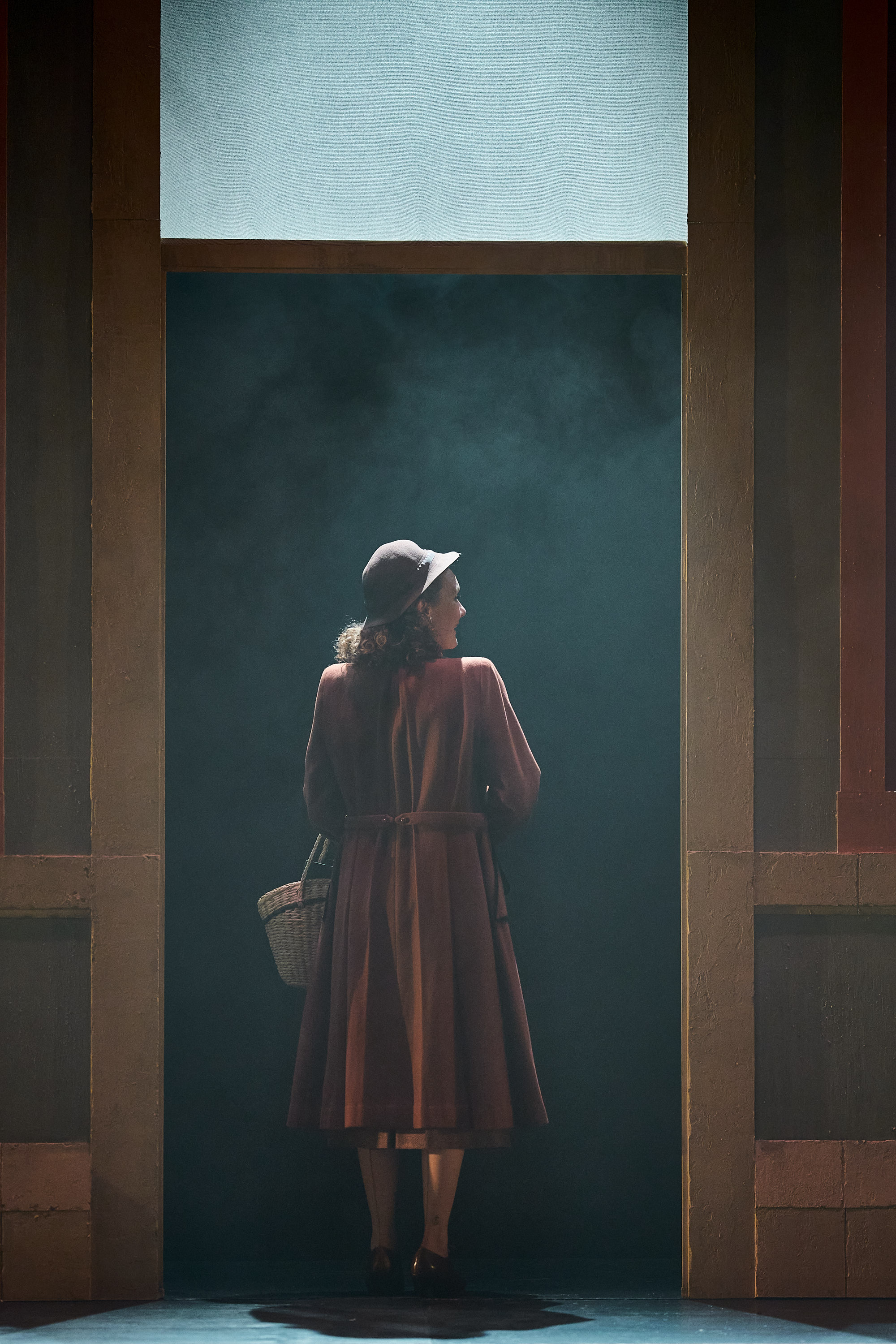 A woman walking through a doorway.
