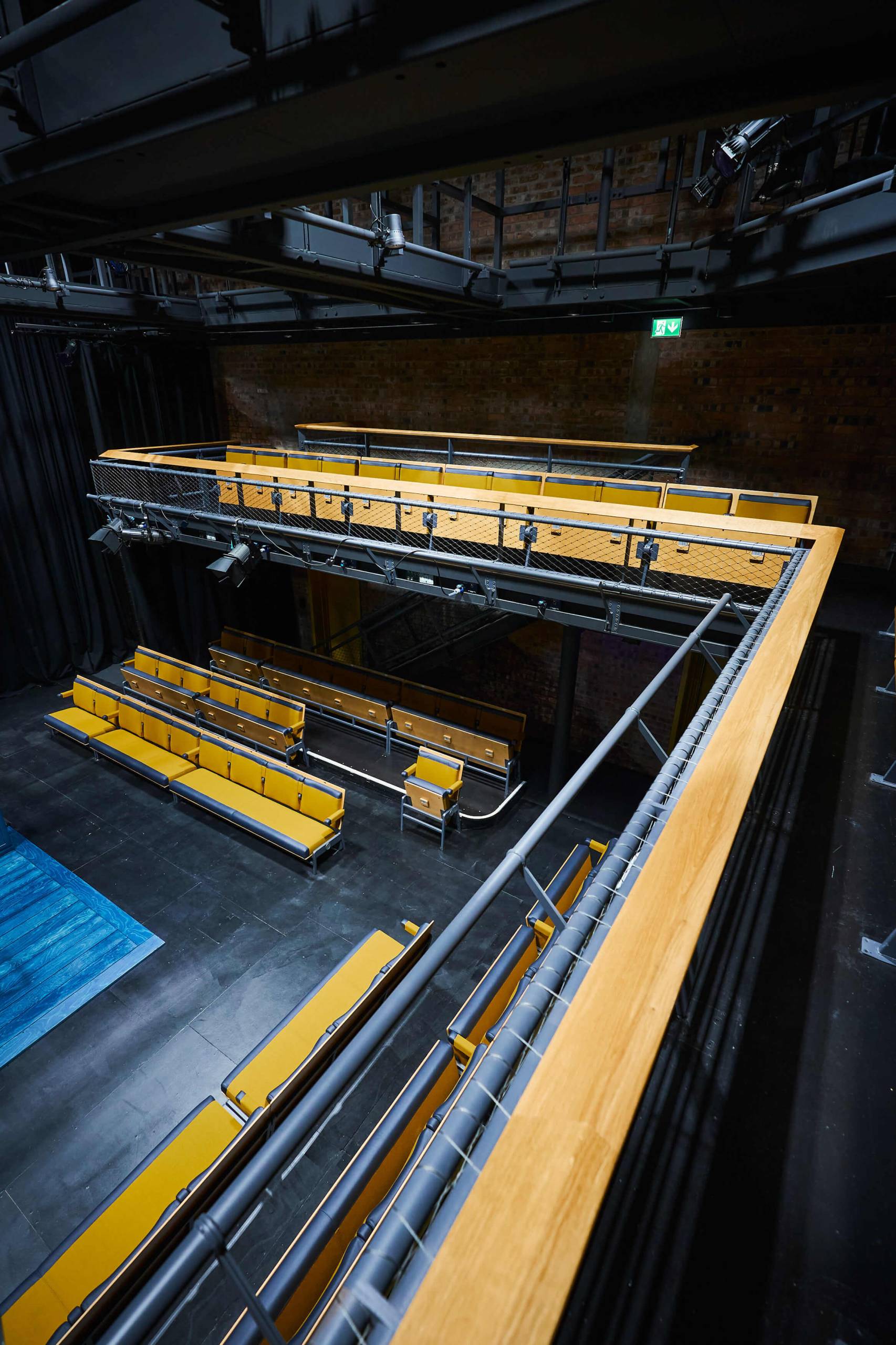 Row of gallery seats overlooking a studio stage